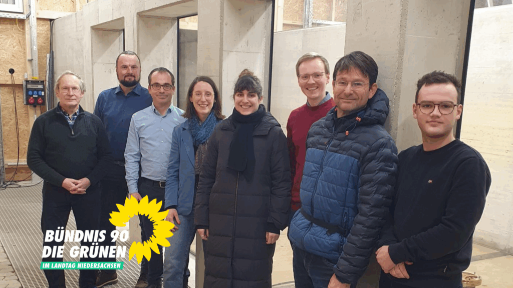 Gruppenbild am Salzwasser-Wellen-Strömungskanal im Leichtweiß-Institut der TU Braunschweig mit grünen Ratsherren, Wissenschaftlern, Swantje Schendel und Marie Kollenrott in der Mitte